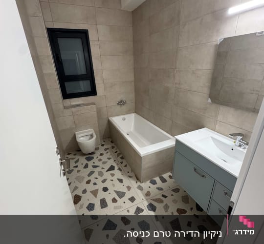 חדר אמבטיה עם אמבטיה, כיור ושירותים